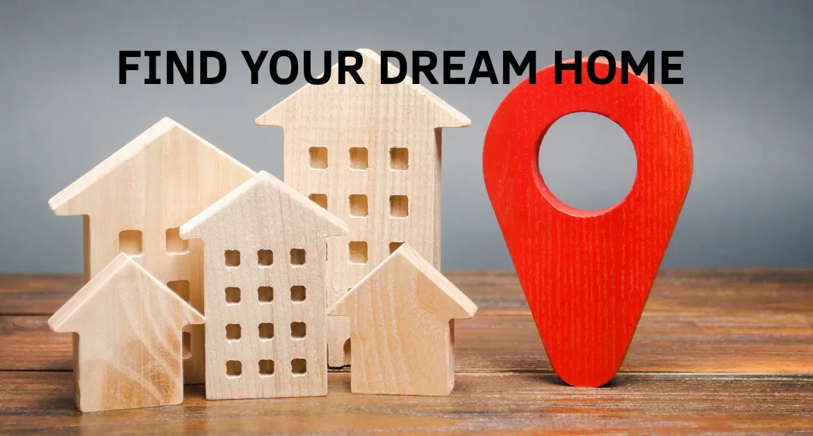 Wooden house models and apartment blocks arranged beside a large red location pin, symbolizing the concept of property search, real estate location, and finding your ideal home.